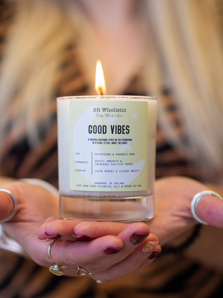 “Stephanie from The Wholistic Haven holding her best-selling aromatherapy candle, handcrafted with essential oils for calming self-care rituals.”