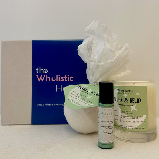 "Chillax & Relax Gift Set displayed beside its gift box, featuring a soothing trio of candle, bath bomb, and aromatherapy rollerball made with cedarwood, geranium, and bergamot."