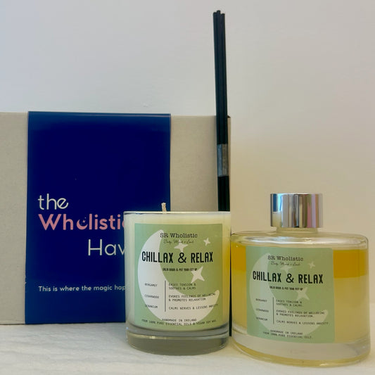 Chillax & Relax candle and diffuser set on a bedside table with soft lighting