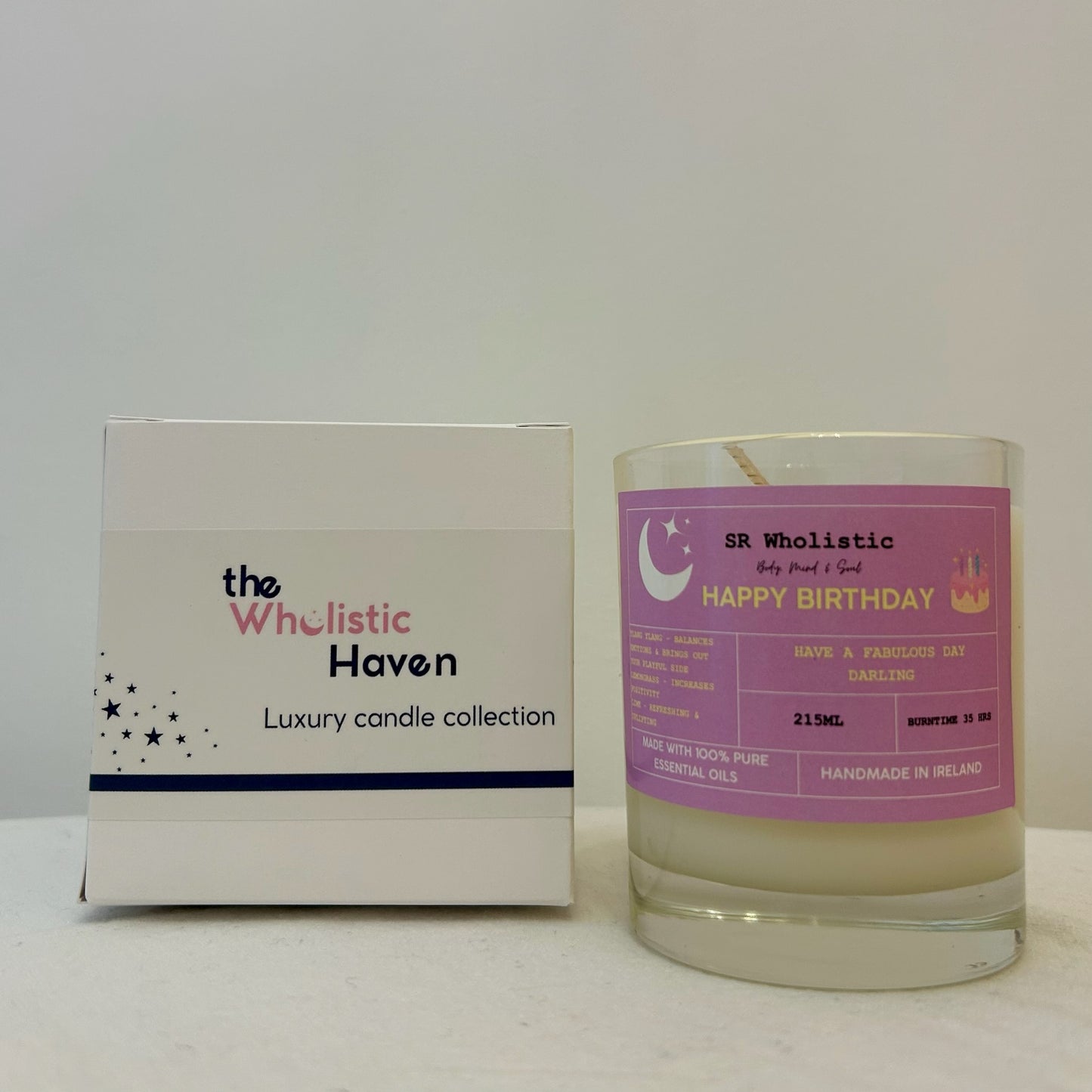 "Happy Birthday candle positioned beside its branded packaging box on a clean, celebratory surface."