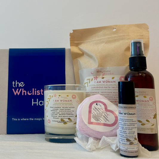 "I am Woman" Menopause gift set featuring a kraft box alongside an aromatherapy scented candle, bath Salts, essential oil rollerball blend, cooling spray and Shower Bomb– perfect for uplifting and refreshing rituals."