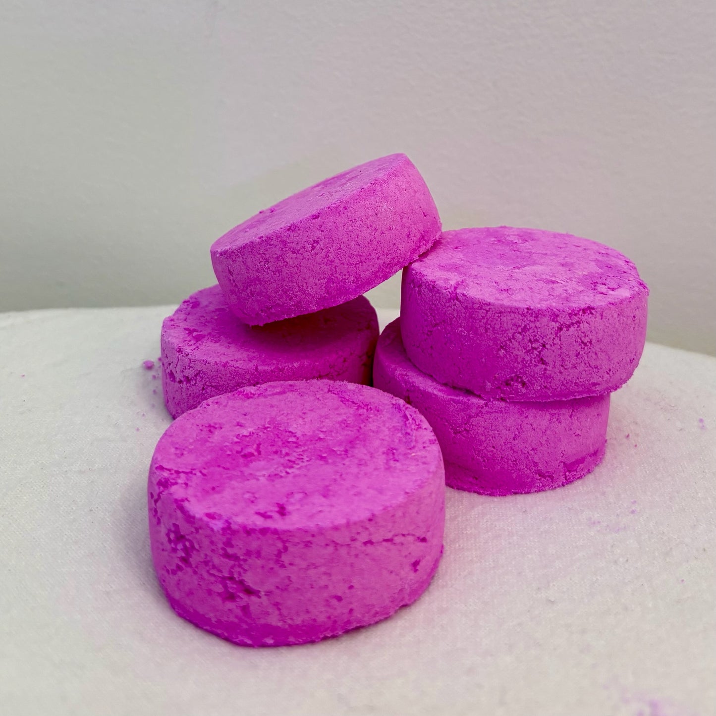 Five round Self Care Shower Bombs displayed on a white background, made with Jasmine, lemongrass & grapefruit essential oils