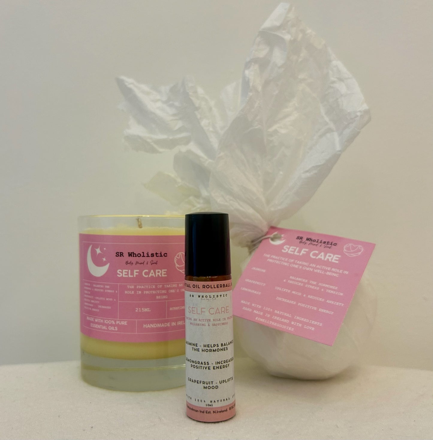 "Self-care gift box with candle, bath bomb, and rollerball blend arranged inside – scented with jasmine, grapefruit, and lemongrass for a vibrant and uplifting wellness treat."