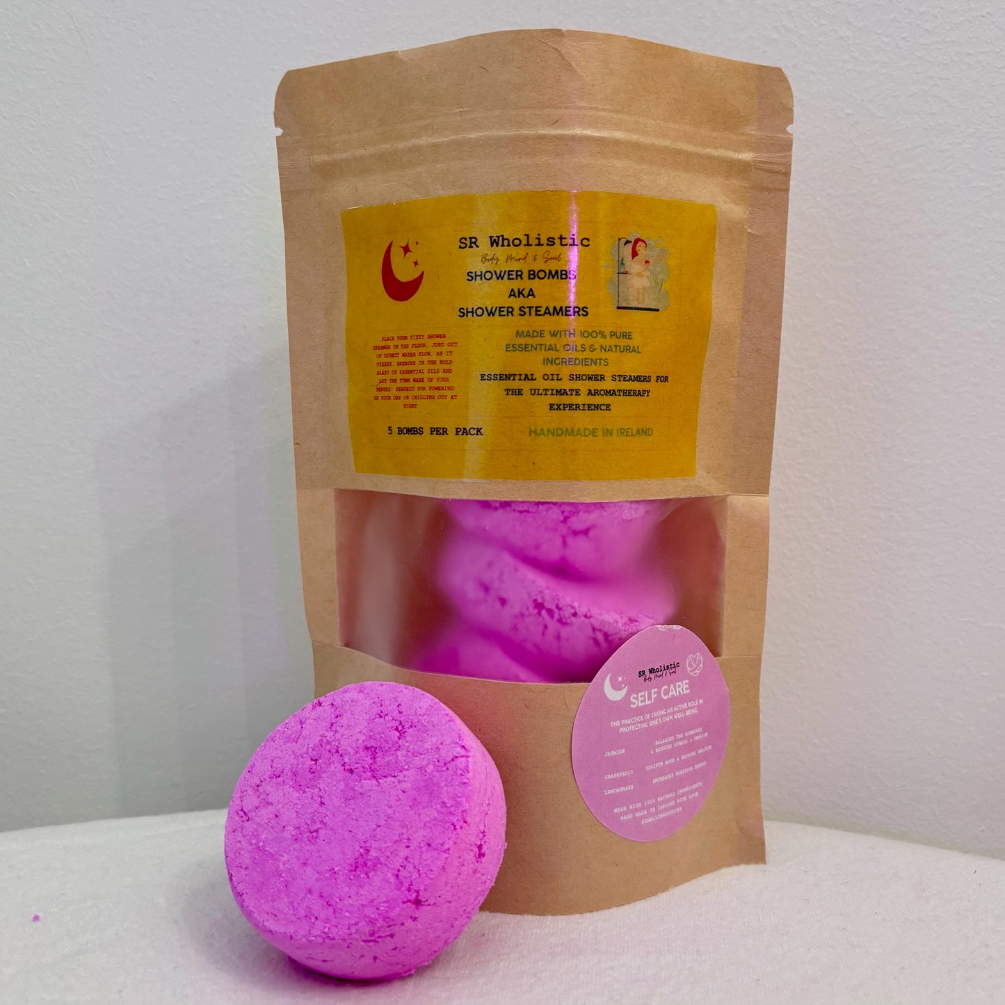 Self Care Shower Bombs pouch with one aromatherapy bomb placed outside for display