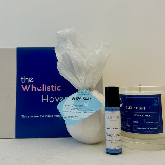 "Sleep Tight Gift Set displayed beside its elegant gift box, featuring a calming trio of candle, bath bomb, and rollerball infused with lavender, geranium, and bergamot essential oils."