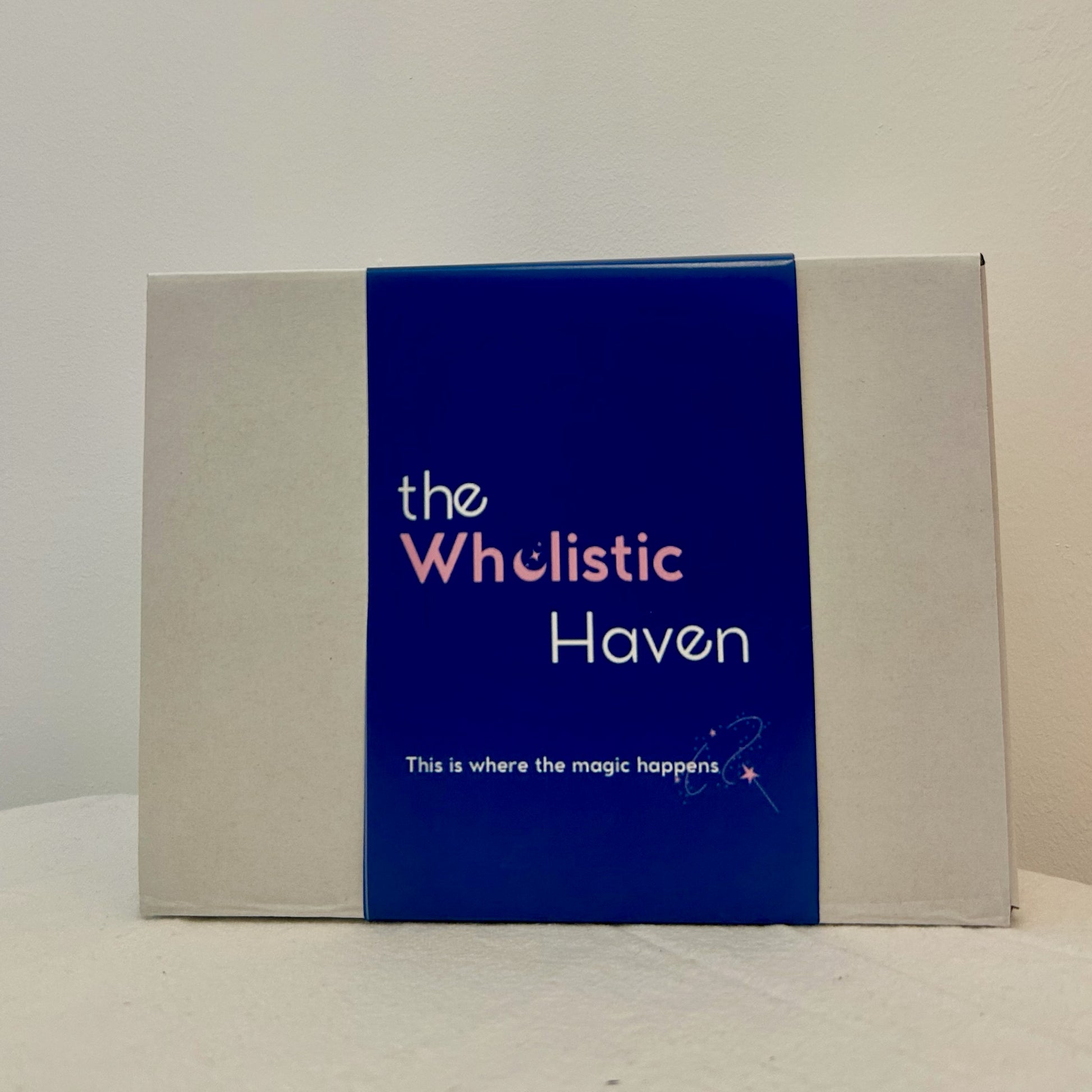 "The Wholistic Haven Gift Box – a closed kraft box wrapped with a branded sleeve featuring a soft wellness-inspired design, perfect for gifting and filled with handcrafted holistic products inside."