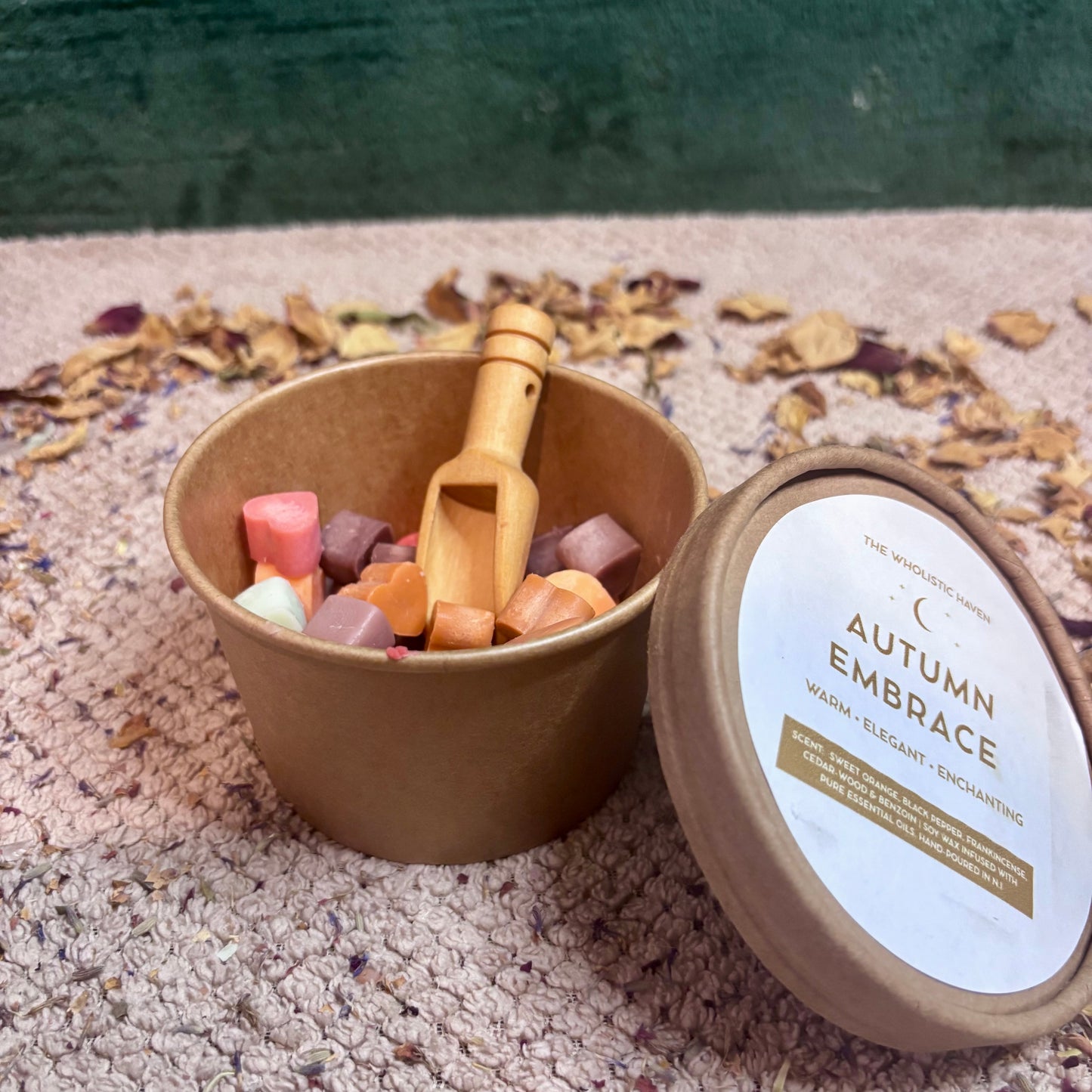 Close-up of Autumn Embrace soy wax melts shaped like leaves, pumpkins and acorns