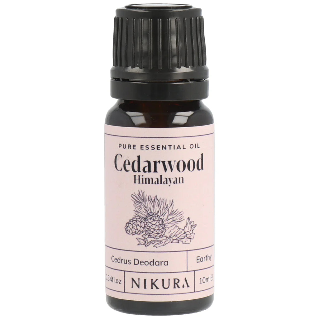 Bottle of Cedarwood Himalayan essential oil with a pink label on a white background