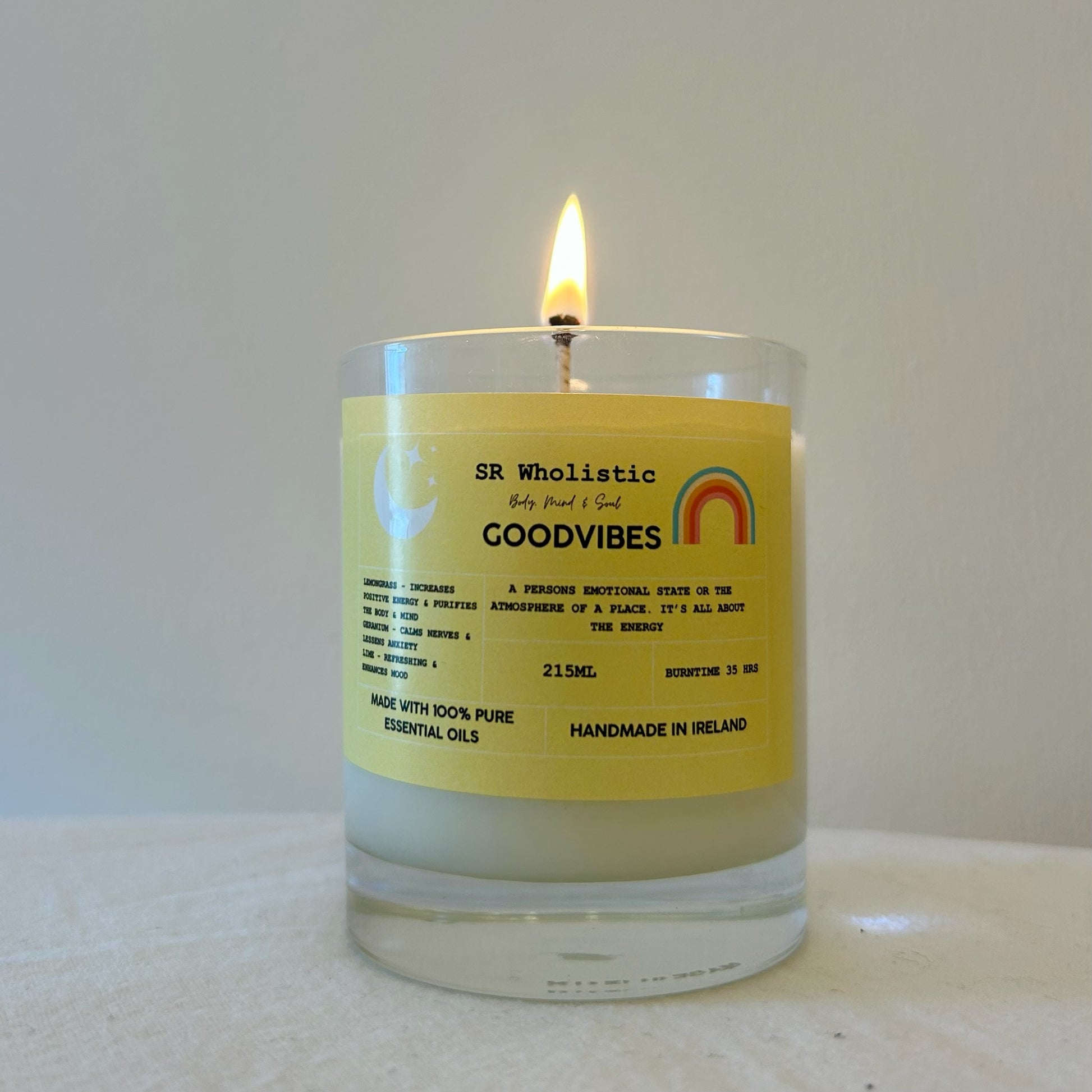 "GoodVibes candle burning softly with a warm glowing flame, creating a cozy atmosphere."