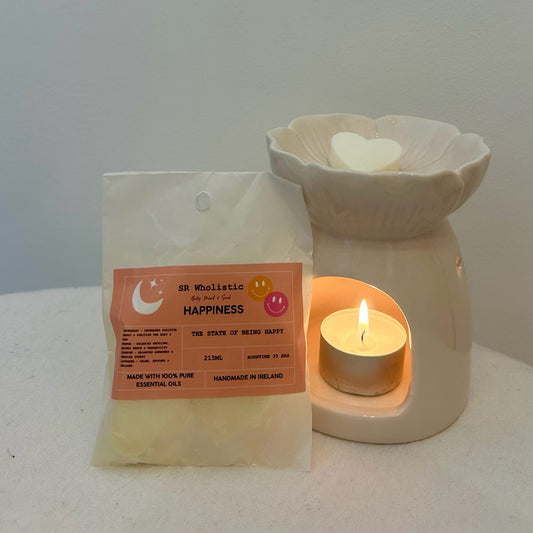 “Happiness Wax Melts gently melting in a wax burner with a glowing tealight, filling the space with a joyful, uplifting citrus-floral aroma.”