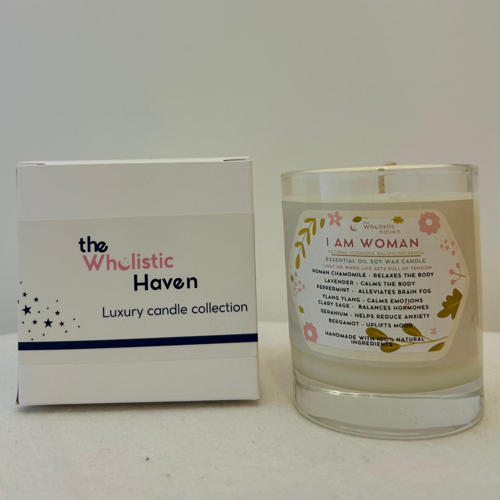 "I Am Woman candle positioned beside its branded packaging box on a clean, confident surface."