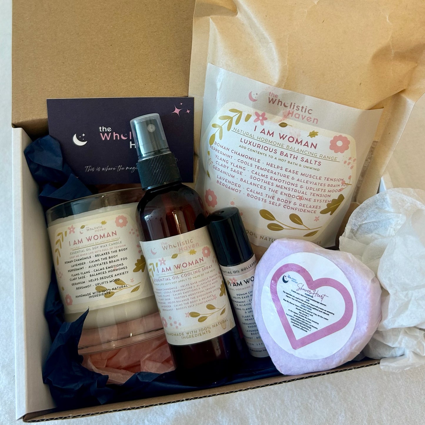 The I am woman gift box with candle, bath Salts, cooling spray, shower bomb and rollerball blend arranged inside – scented with 7 different essential oils which help target menopausal symptoms for a vibrant and uplifting wellness treat."