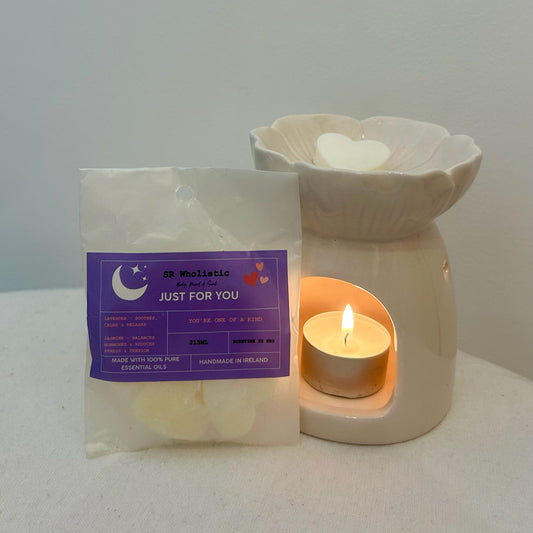 “Just for You Wax Melts melting in a wax burner with a lit tealight, releasing a soothing lavender and jasmine aroma into a peaceful setting.”