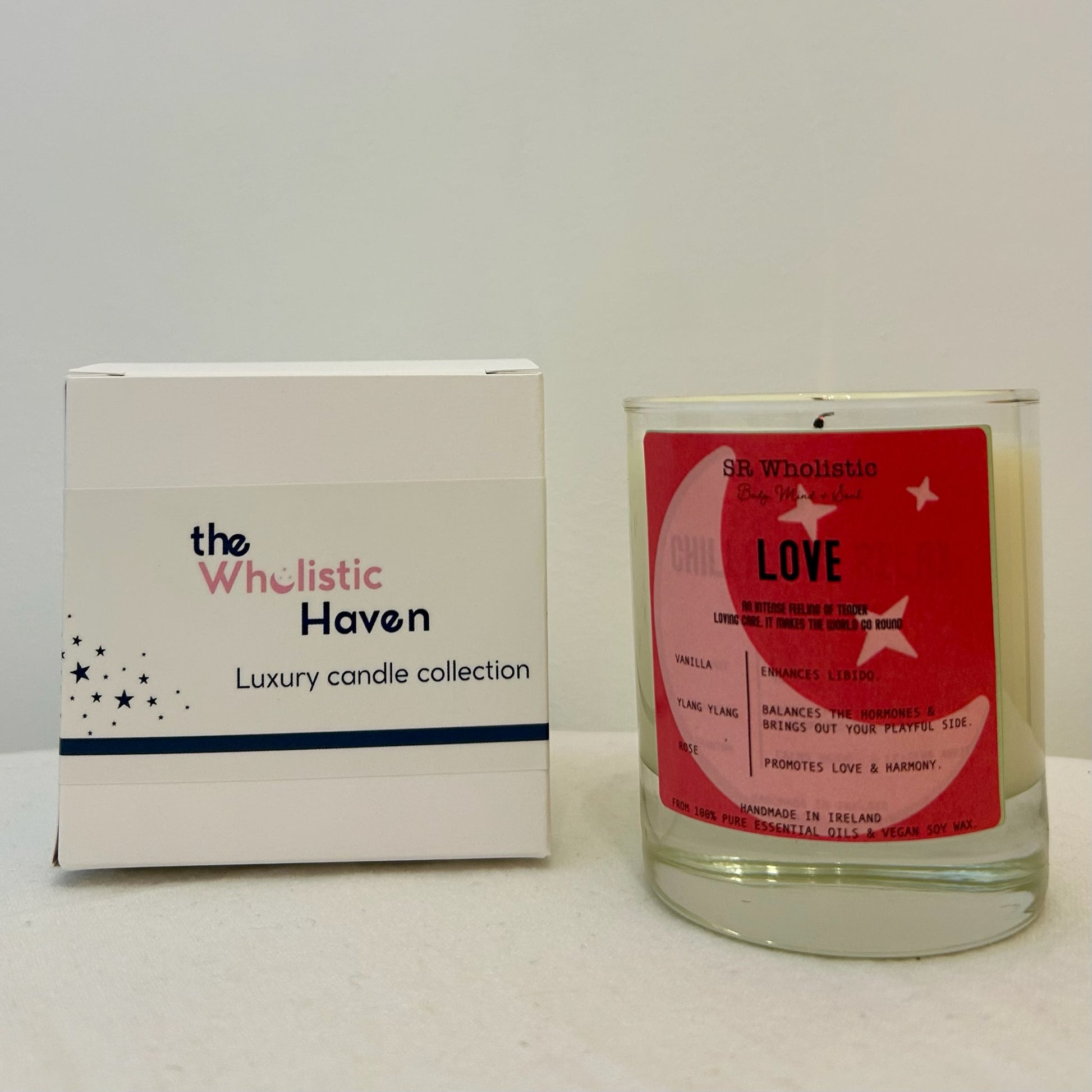"Love candle placed beside its branded packaging box on a clean, serene surface."