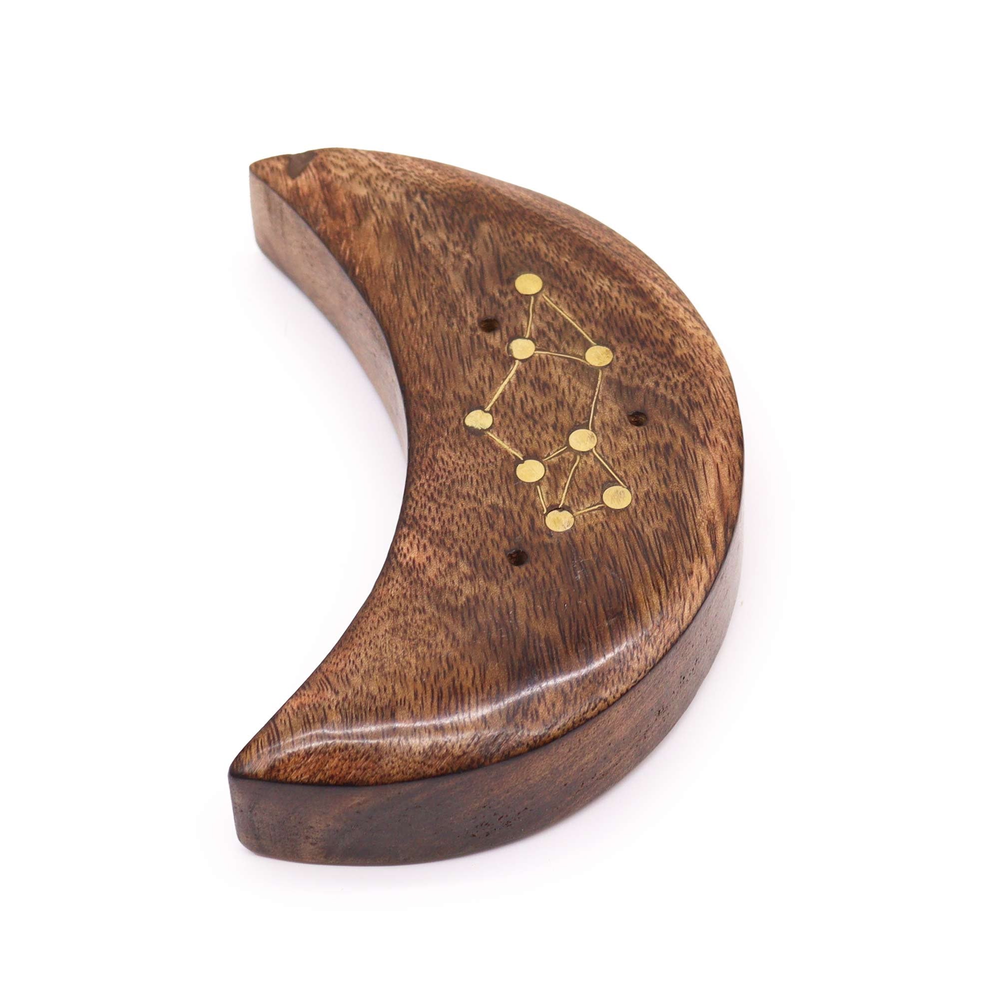 Wooden crescent moon-shaped object with gold constellation design on a white background