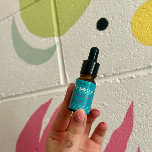 20ml amber glass bottle of Perineal Massage Oil with geranium and lavender, handcrafted by The Wholistic Haven for gentle birth preparation and third trimester skincare.