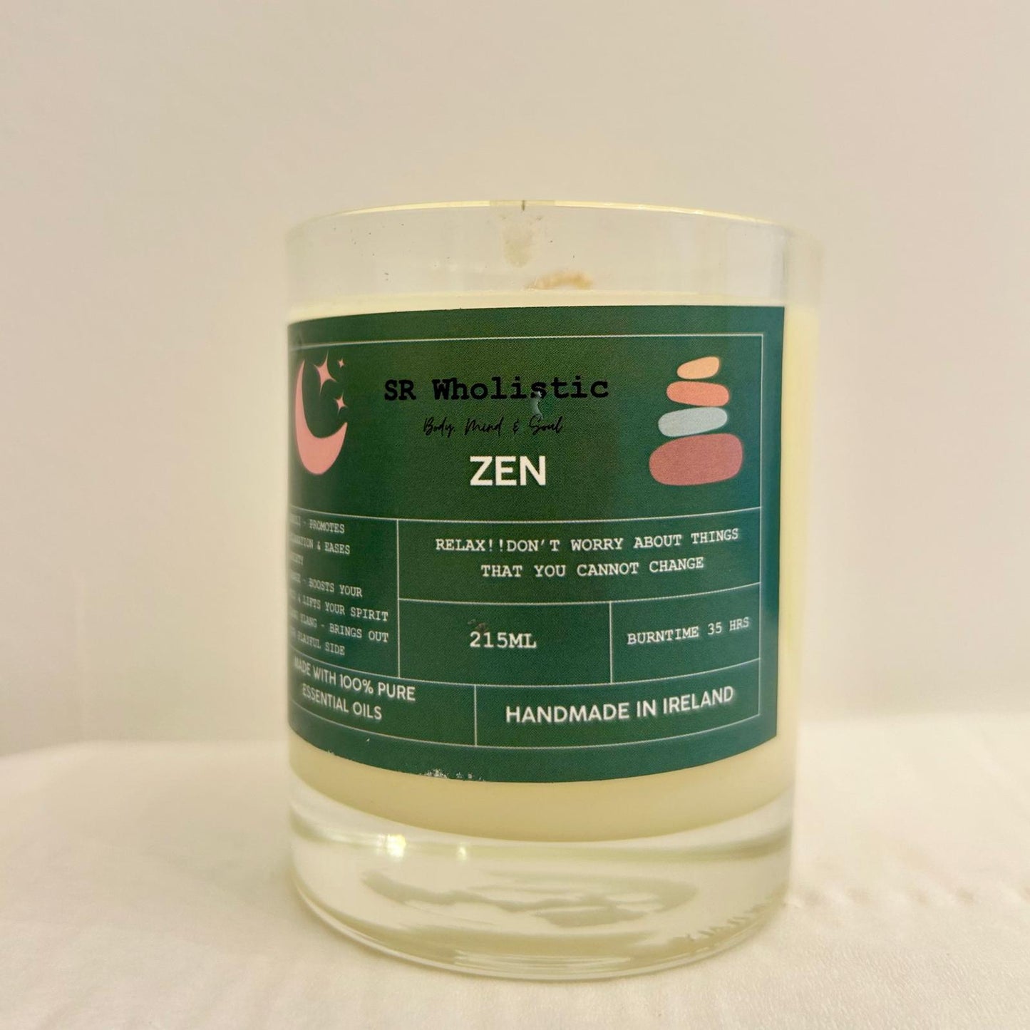 "Zen candle in a clear glass jar with label clearly visible, standing alone on a neutral background."