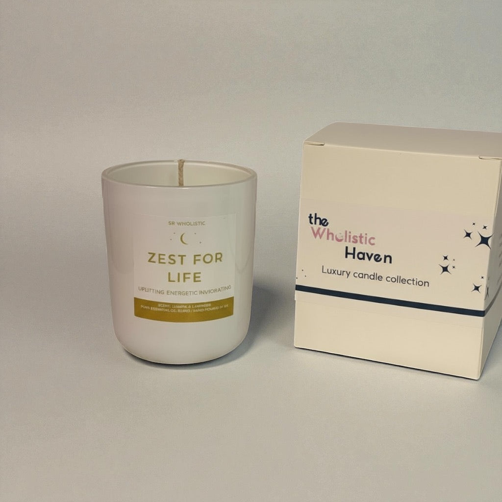 “Zest For Life candle in a glossy white jar displayed beside its matching branded box, styled on a clean white surface.”