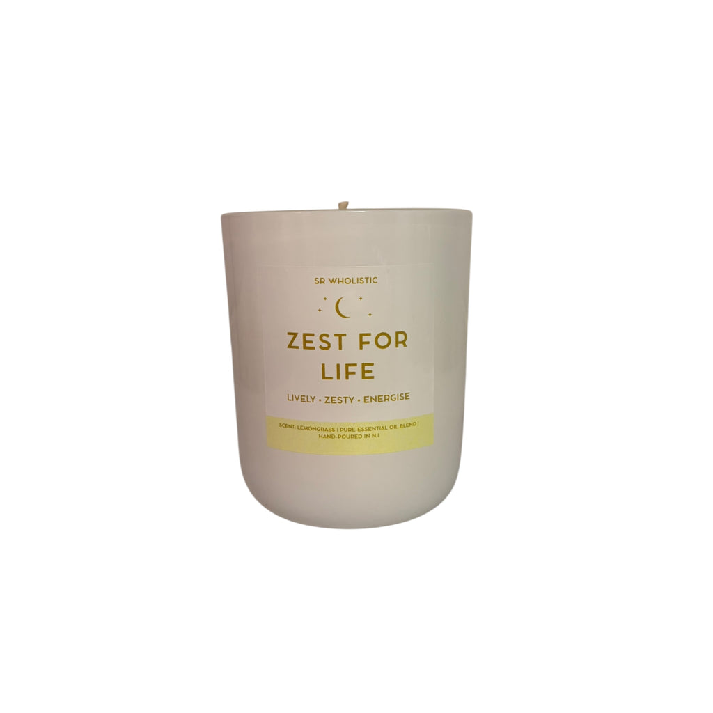 “Close-up view of the Zest For Life essential oil candle in a glossy white jar, showing the clean gold and white label against a bright white background.”