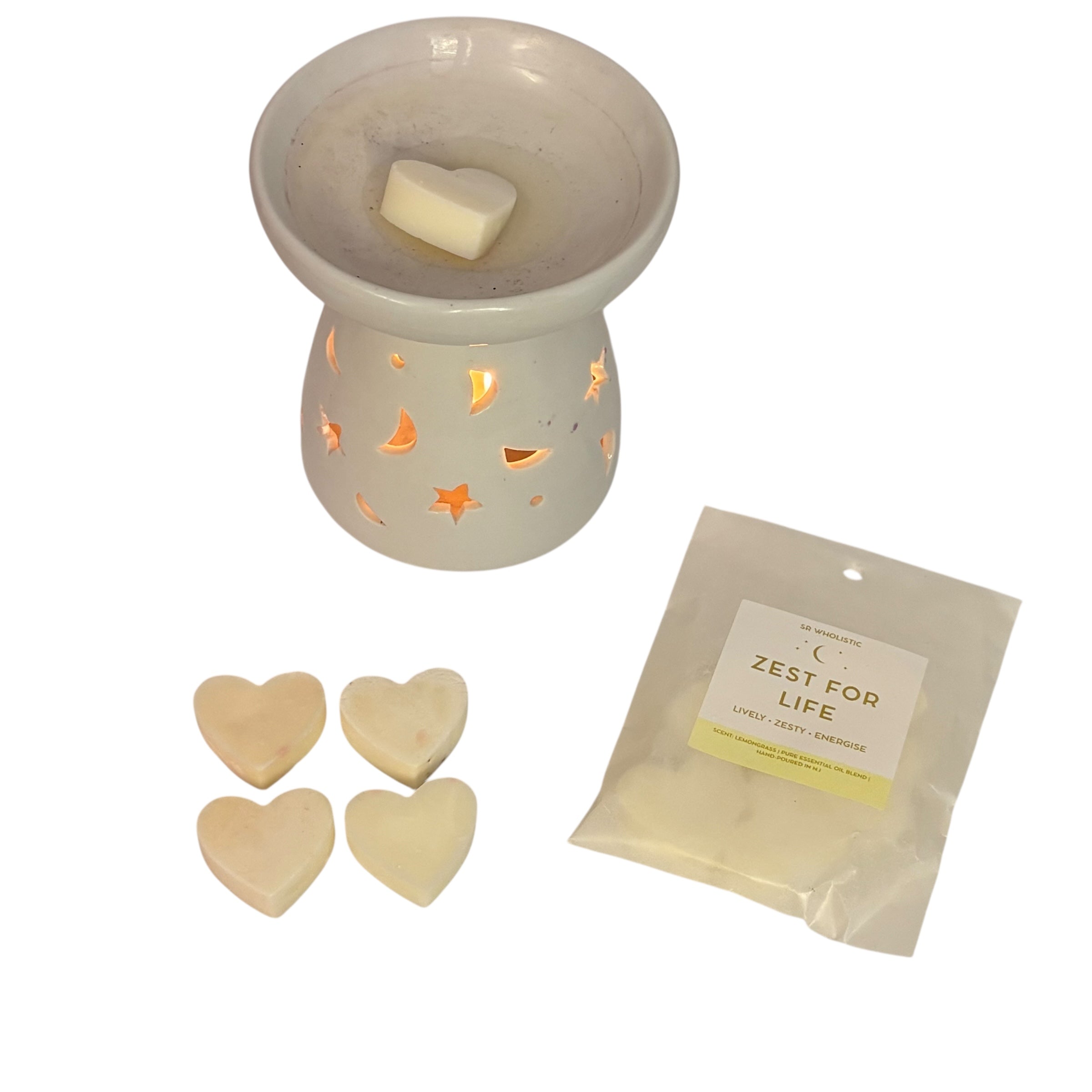 “White ceramic wax burner glowing with warm light, with a heart-shaped wax melt on top, four matching heart melts beside it, and a SR Wholistic ‘Zest For Life’ wax melt pack on a clean white background.”