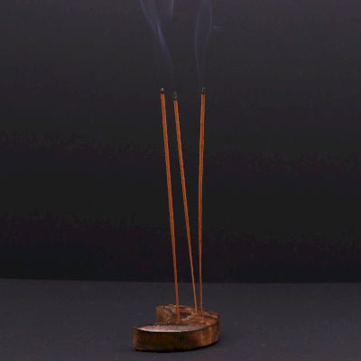 Incense sticks with smoke on a dark background