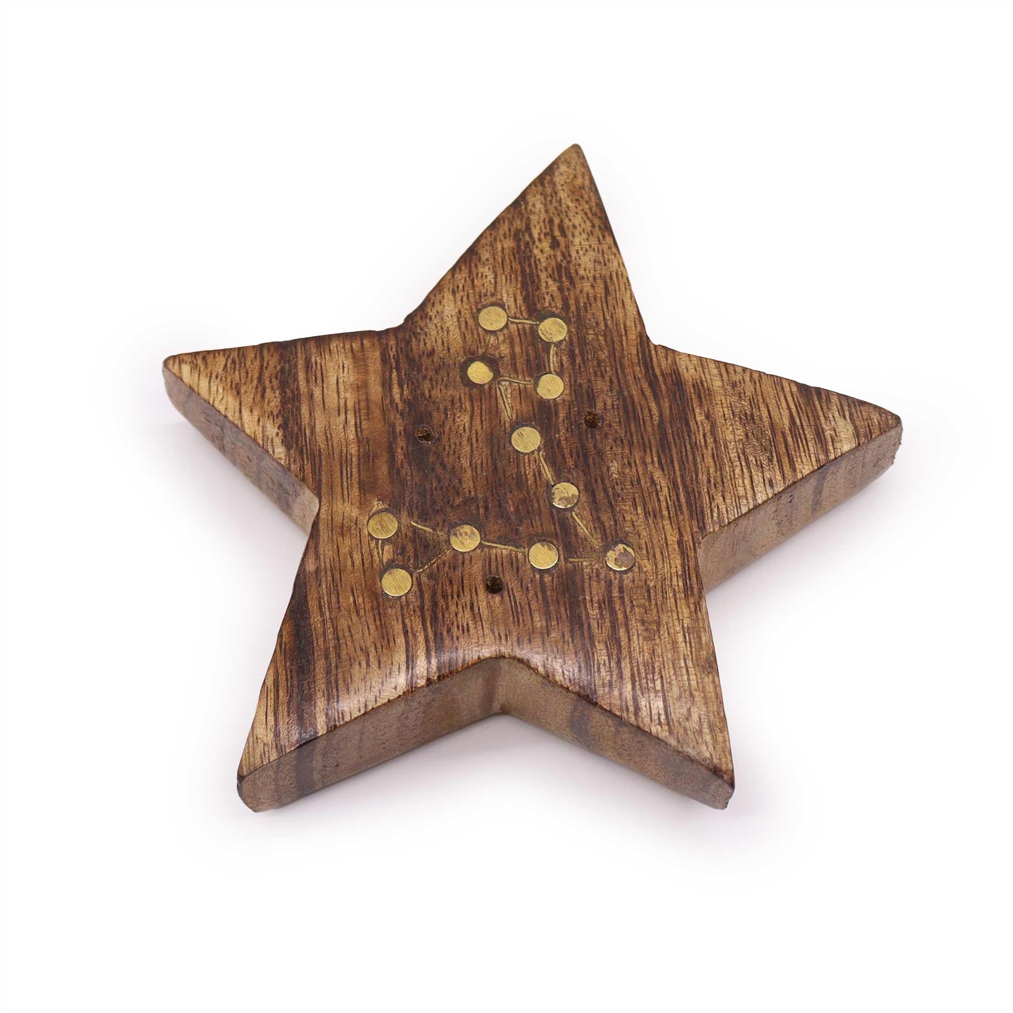 Wooden star-shaped object with embedded gold coins on a white background