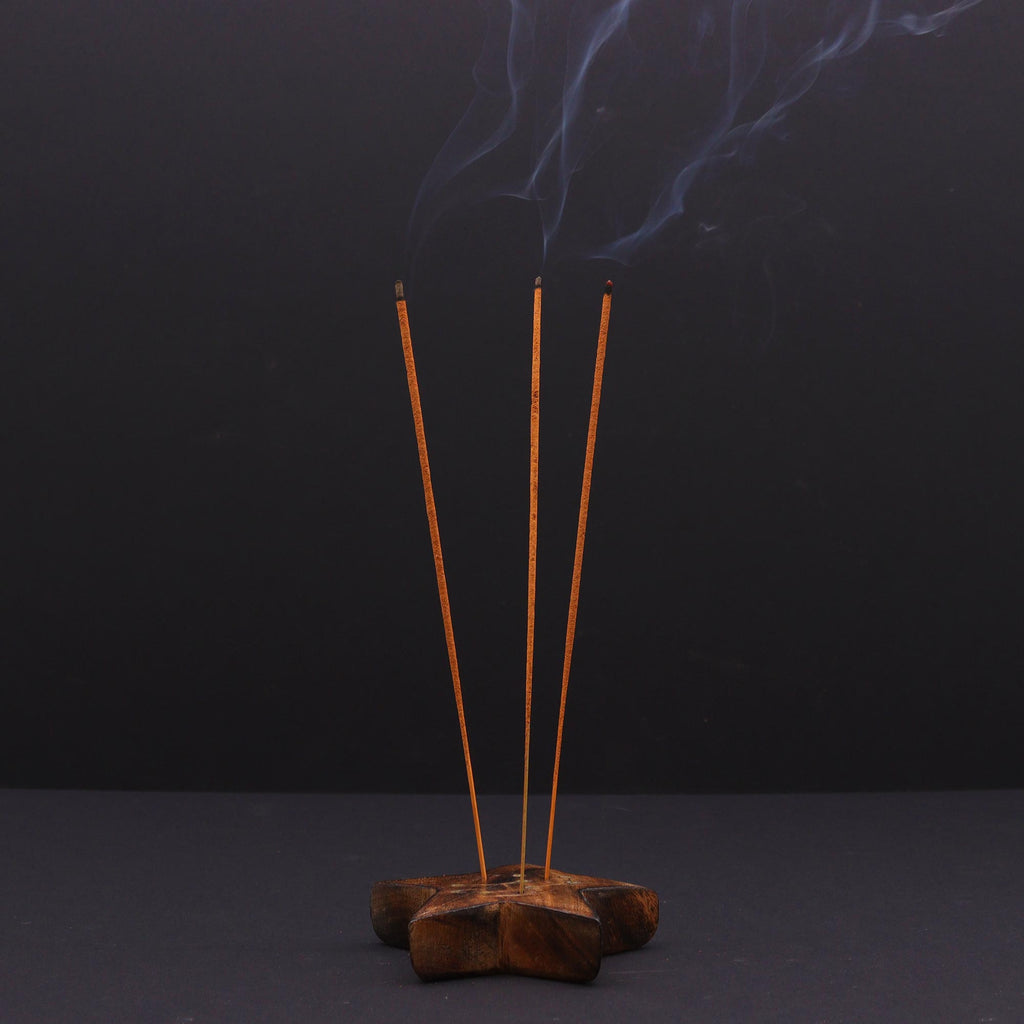 Incense sticks with smoke on a dark background