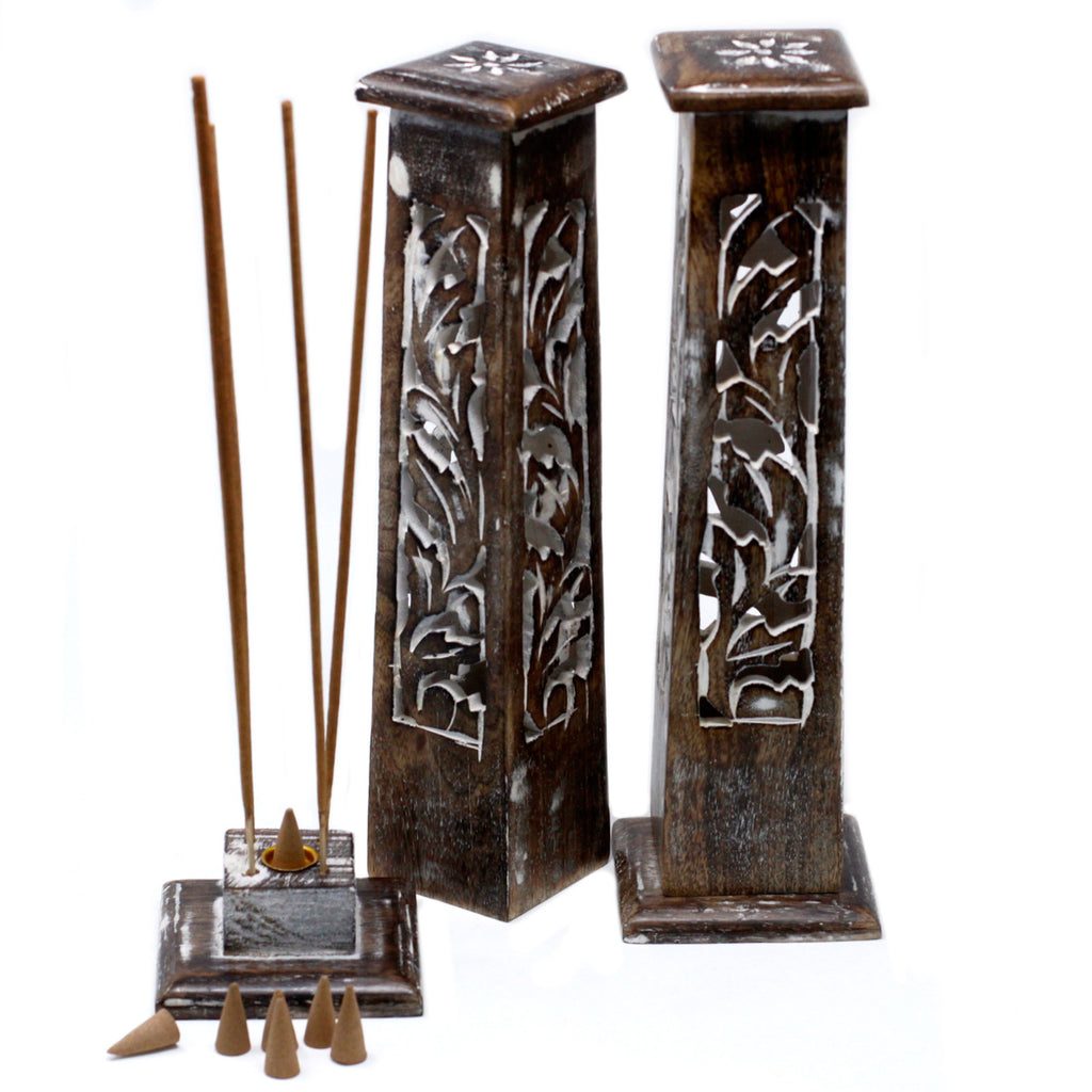 Decorative incense holders with incense sticks and cones on a white background